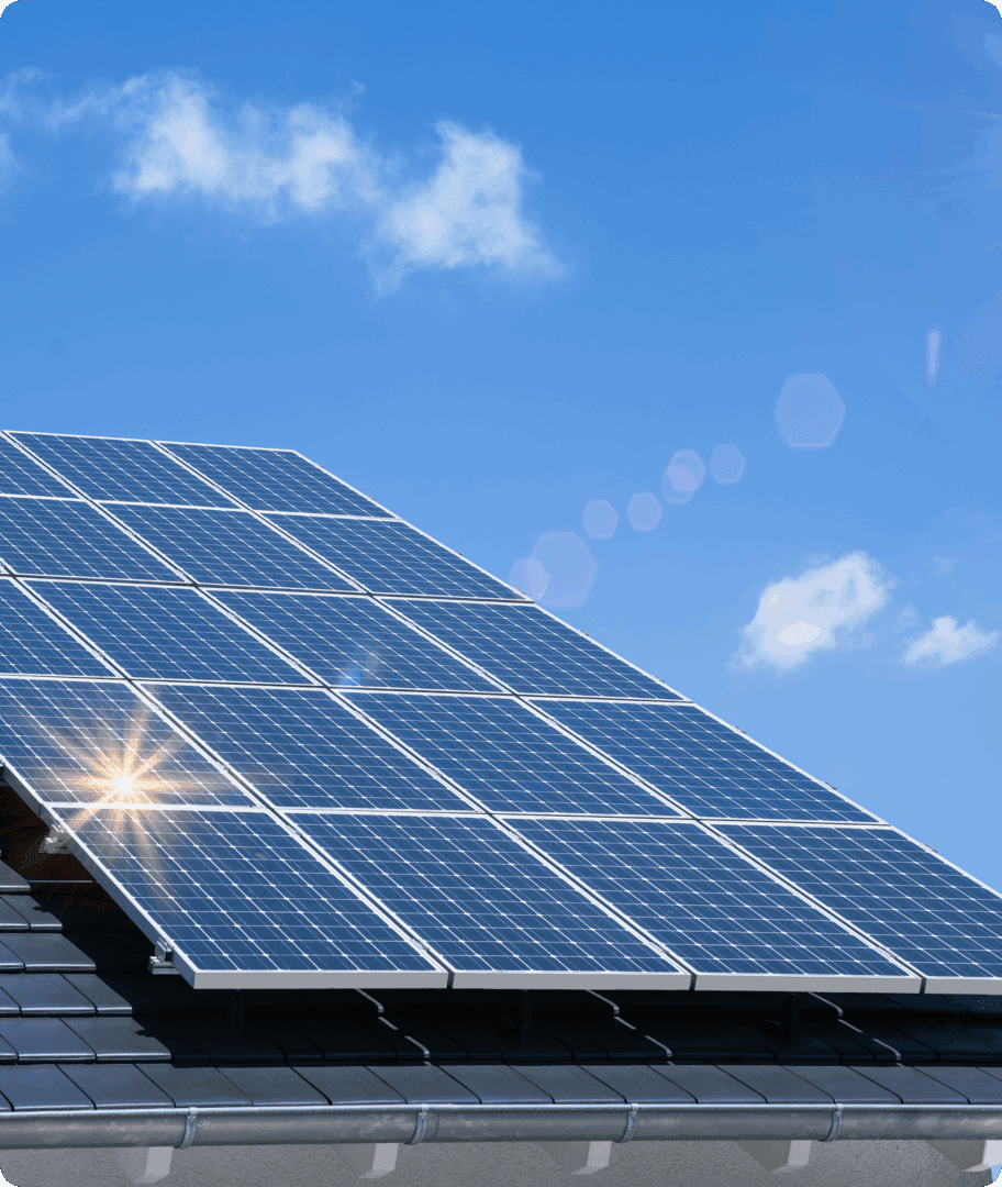 Solar panels on roof under blue sky.