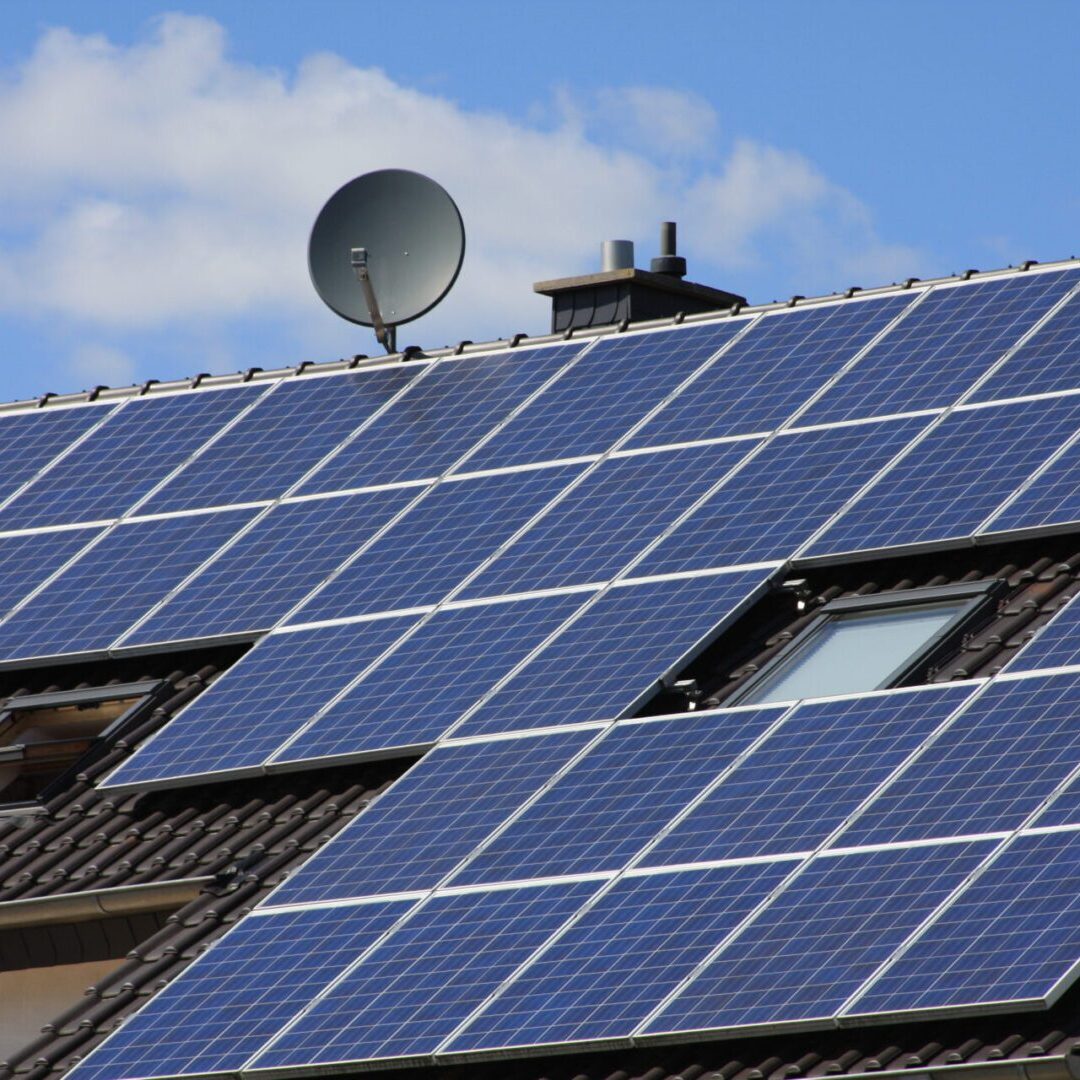Rooftop solar panels with satellite dish.